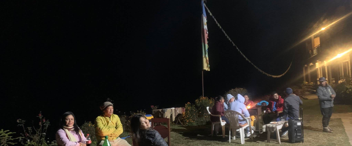 Guests around the garden campfire at night