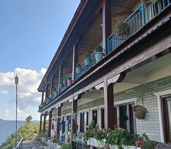 The wooden balconies of the lodge lined with flower pots