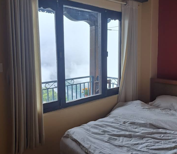 A bright room with valley mist outside the window